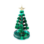Assembled Magic Growing Paper Christmas Tree decoration on wooden surface