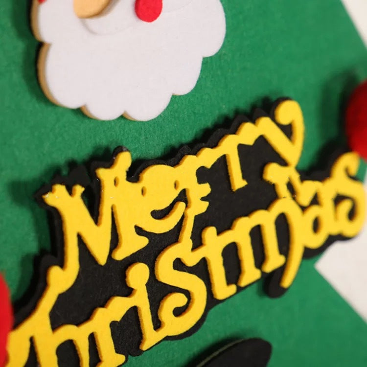 Handmade felt ornament in Christmas tree shape against wooden backdrop