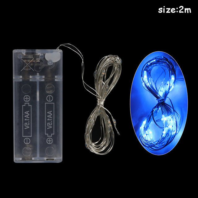 Close-up of festive Christmas LED light string with holiday-themed decorations