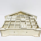 Wooden Christmas calendar cabinet with Christmas greenery and candles nearby