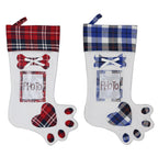 Red and blue dog paw Christmas gift stocking flat lay view