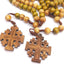 Wooden crucifix pendant with rosary beads close-up