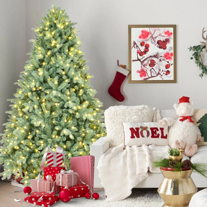 Close-up of green Christmas tree branches with soft warm white LED glow