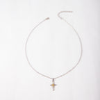 Cross pendant with floral center detail on delicate chain