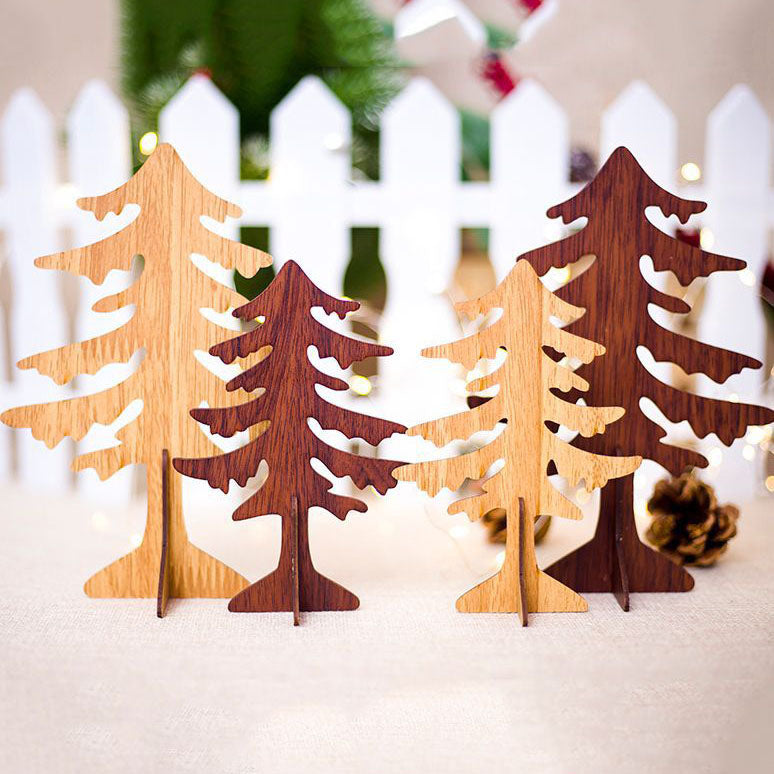 Wooden elk Christmas ornament alongside red berries and holly on a snowy mantle