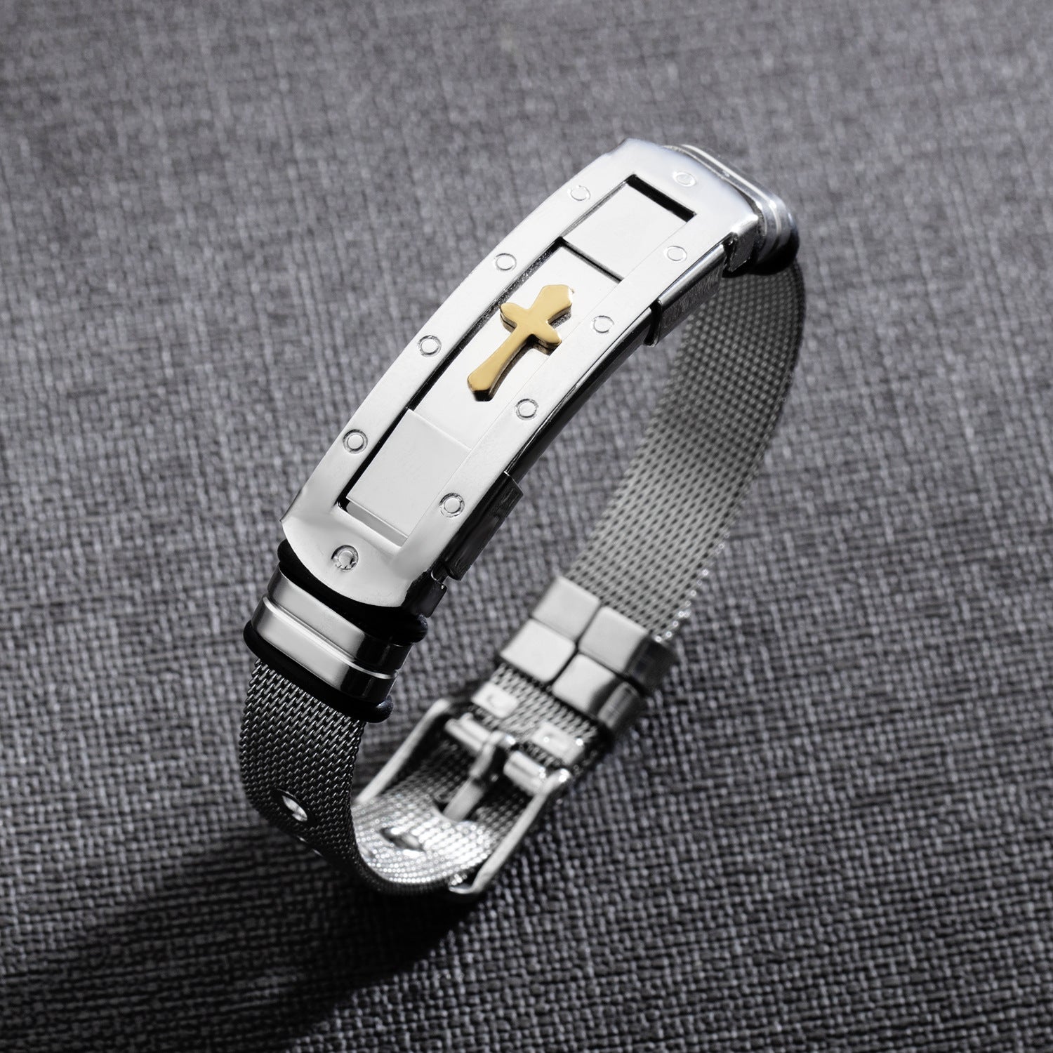 Close-up view of stainless steel cross bracelet charm