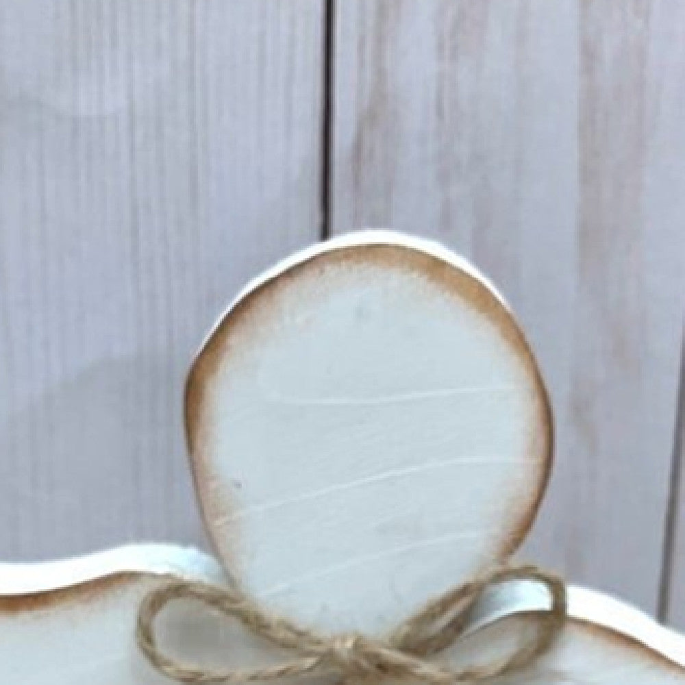Close-up of carved wooden Jesus figure on tray