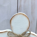 Close-up of carved wooden Jesus figure on tray