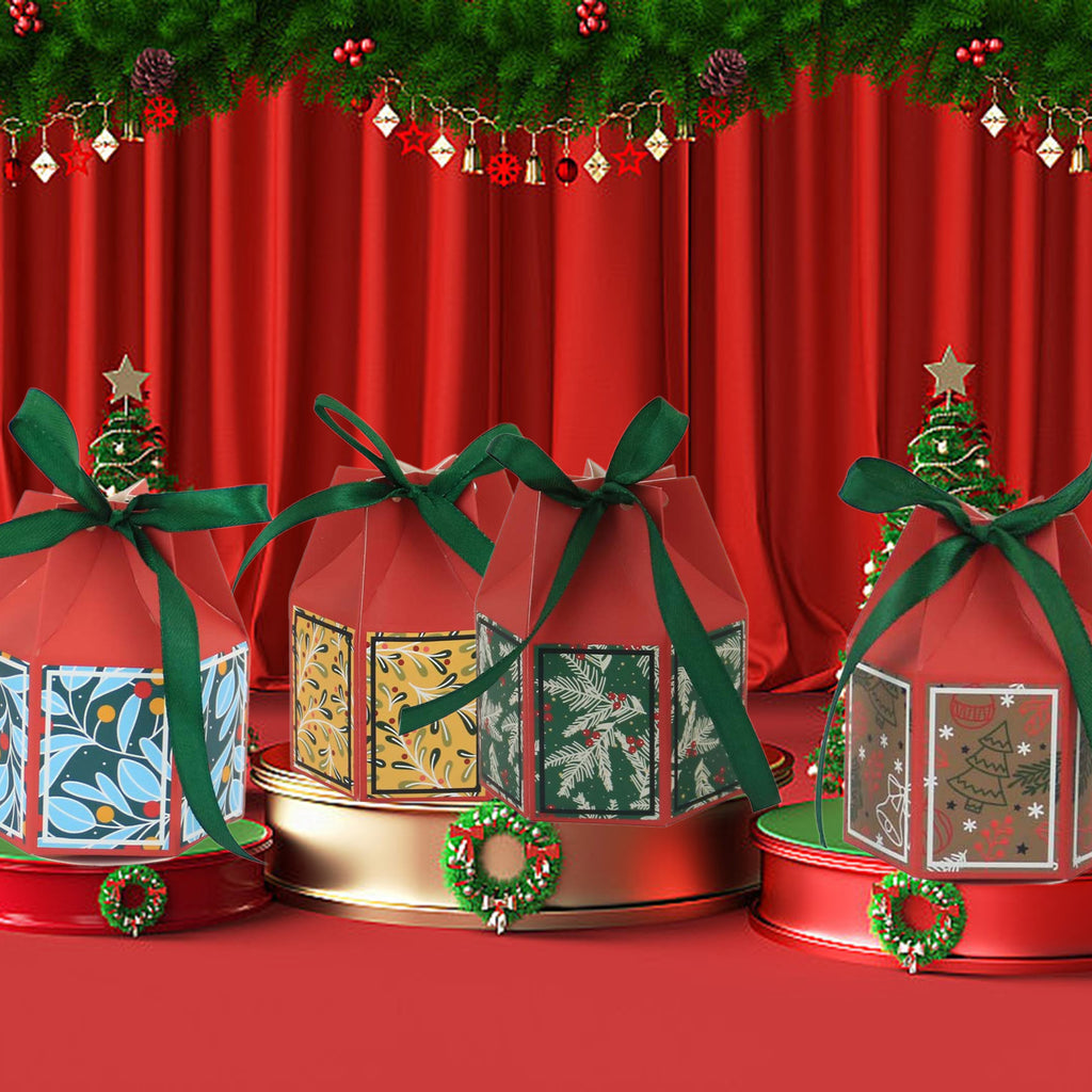 Christmas bell paper favor box in green with pre-attached ribbon displayed with holiday greenery and pinecones