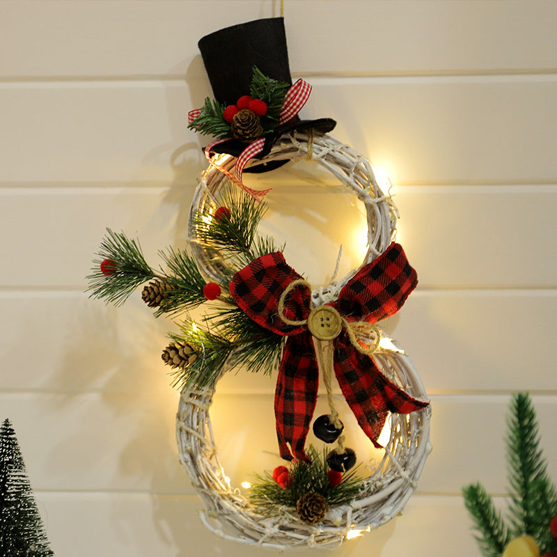 Close-up of LED lit Christmas wreath pendant showing evergreen texture and illumination