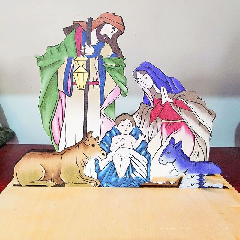 Wooden nativity scene decoration with hand-carved figures depicting Mary, Joseph, and baby Jesus in the manger