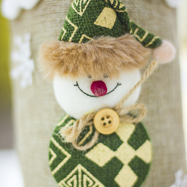 Festive Christmas wine bottle cozy displayed on a holiday table with warm lighting