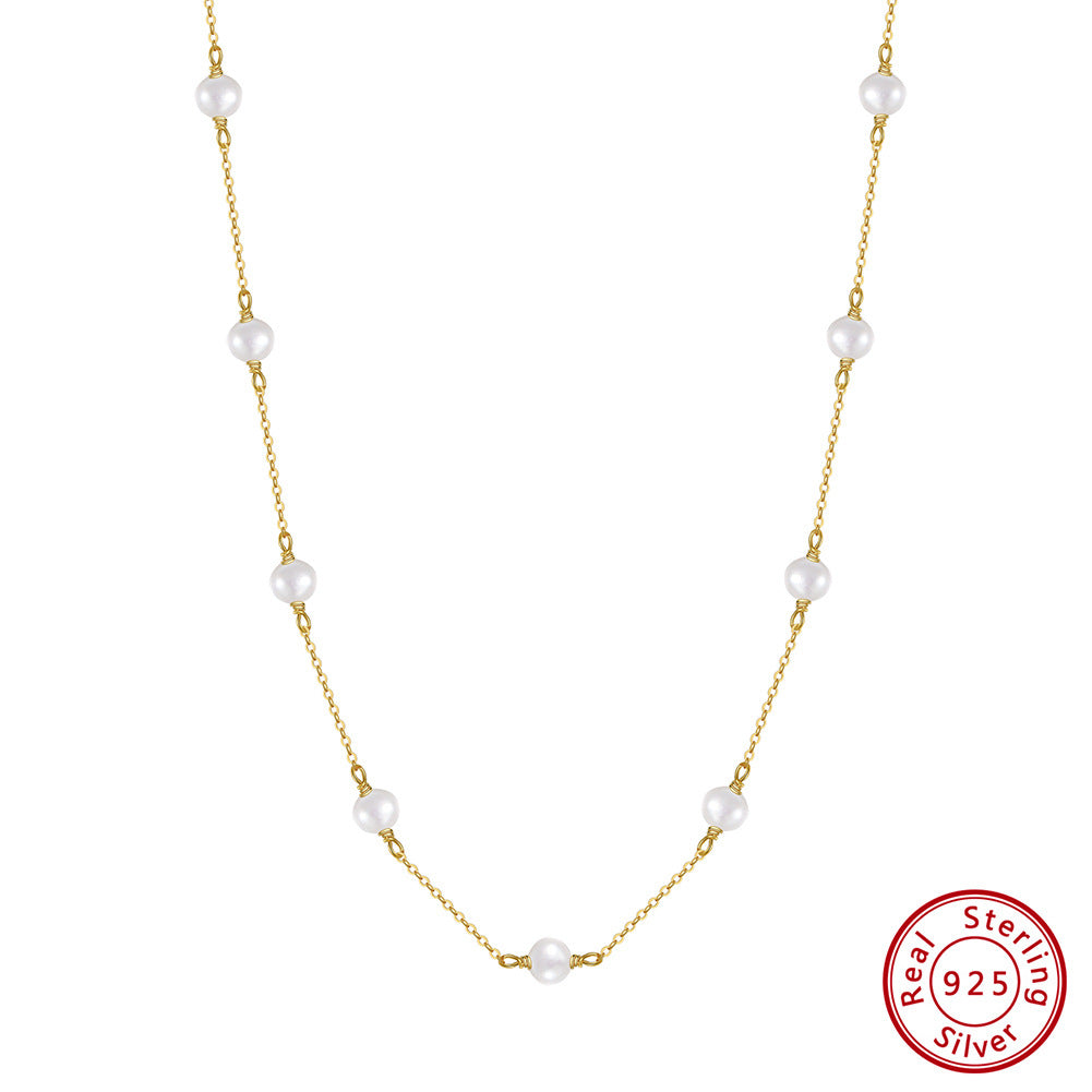 Pearl pendant detail on hammered sterling silver cross chain necklace
