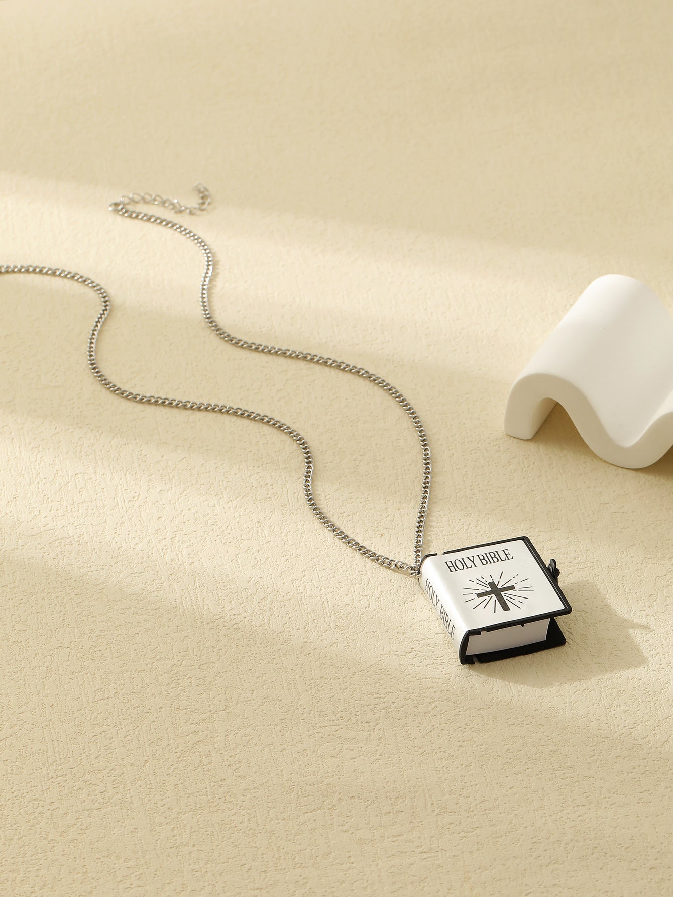 Unisex cross pendant necklace styled on chain display