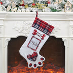 Dog paw Christmas stocking displayed on fireplace mantle with holiday decorations