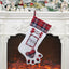 Dog paw Christmas stocking displayed on fireplace mantle with holiday decorations