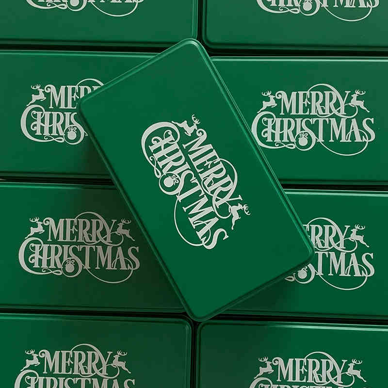 White Christmas cookie tin with green printed holiday design