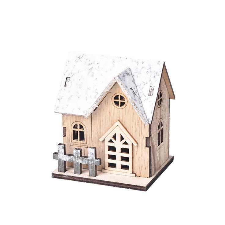 Warm glowing wooden Christmas cabin on a festive table