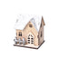 Warm glowing wooden Christmas cabin on a festive table