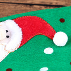 Red and green wine bottle cover adding Christmas cheer to dinner table setting