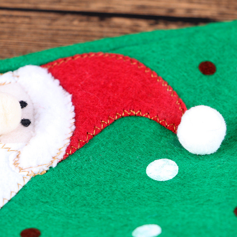 Red and green wine bottle cover adding Christmas cheer to dinner table setting