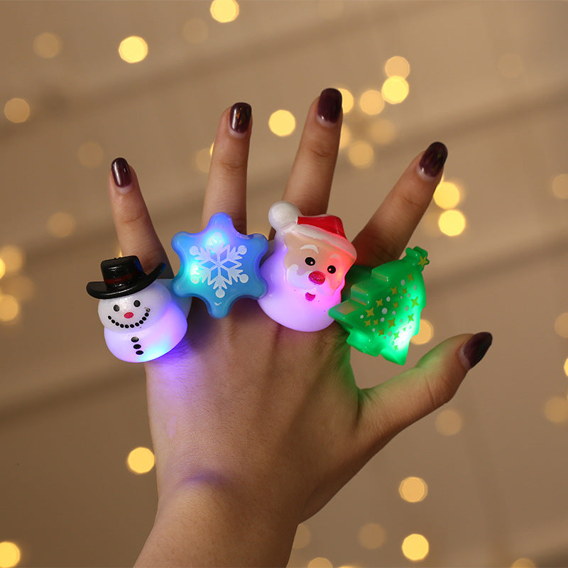 Small tree-shaped Christmas finger light glowing red