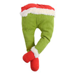 Christmas garden decoration featuring colorful elf legs stakes in outdoor setting