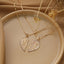 Gold electroplated twin heart pendant necklace with Jesus pattern detail