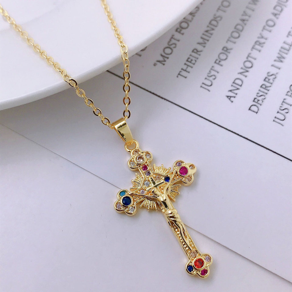 Lifestyle view of gold cross pendant necklace worn by model