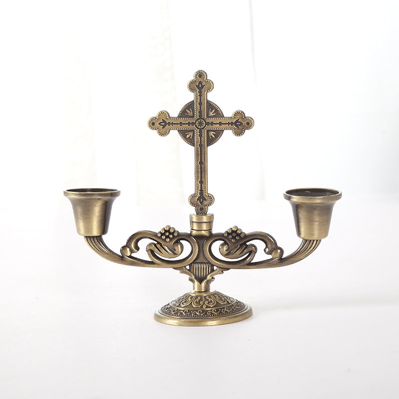 Ornate cross-shaped candle holder in zinc alloy for home prayer spaces