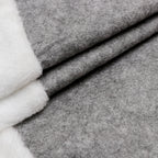 Close-up of elegant gray British leaf design on Christmas tree skirt