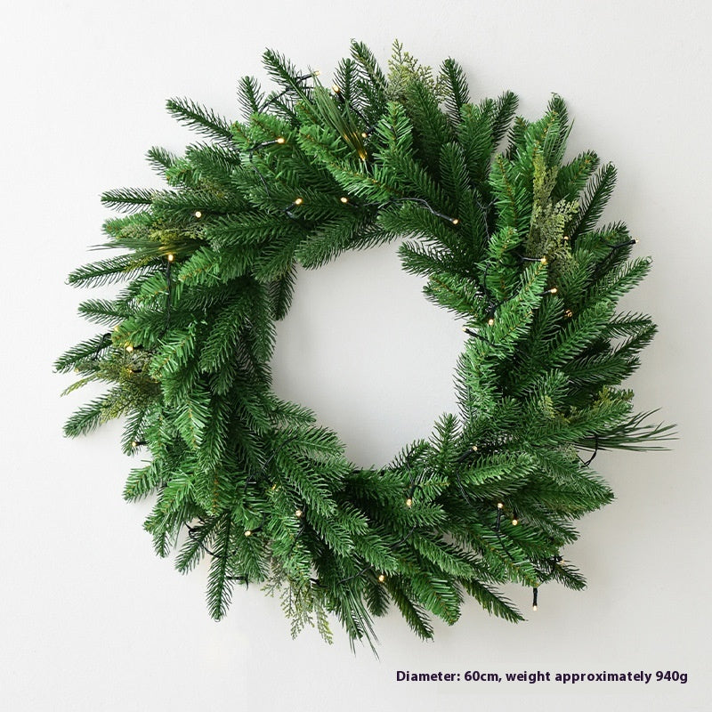 Pine leaf garland hanging above door frame in decorated home entrance