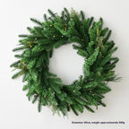 Pine leaf garland hanging above door frame in decorated home entrance