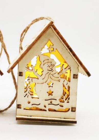 Small wooden house Christmas decorations displayed on Christmas tree branches