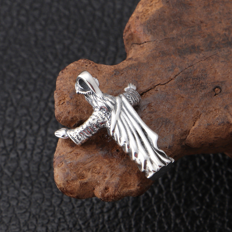 Close-up detail showing vintage distressed texture on sterling silver Jesus pendant