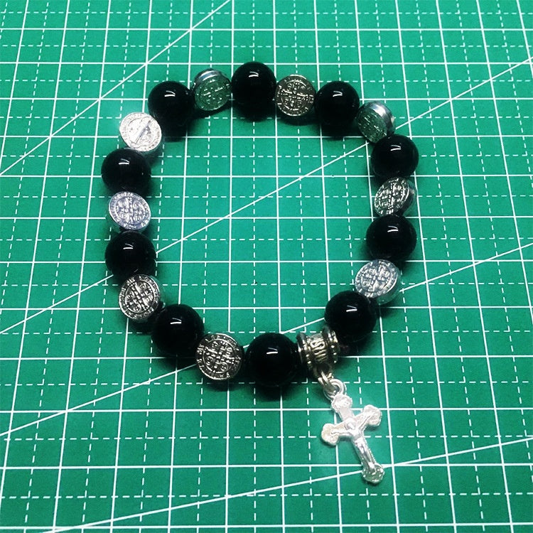 Unisex Saint Benedict rosary bracelet on wrist demonstrating comfortable fit and casual style