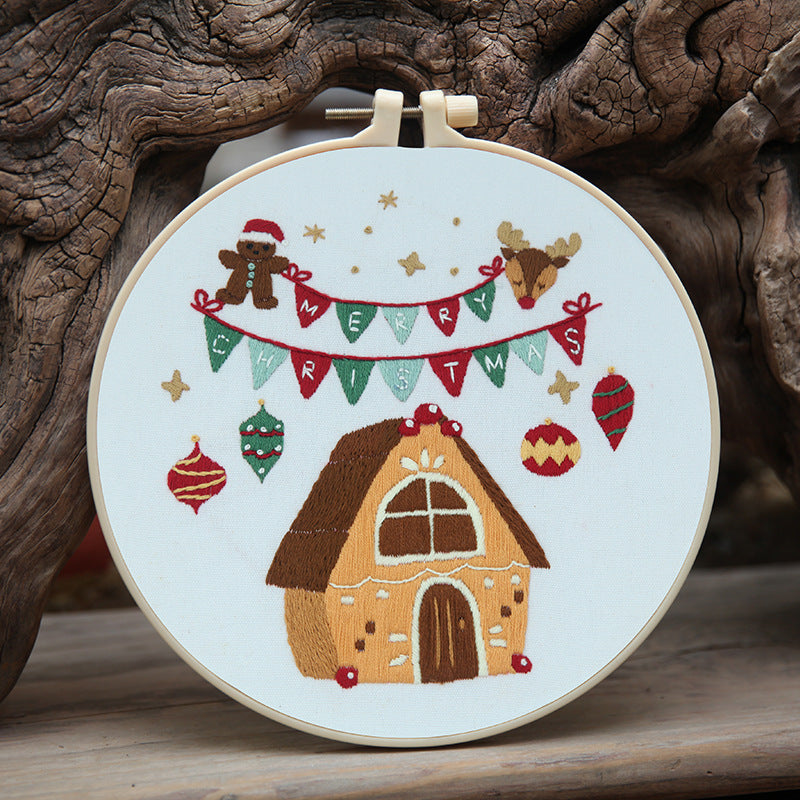 Christmas craft kit contents laid out showing embroidery materials and frame components
