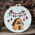 Christmas craft kit contents laid out showing embroidery materials and frame components