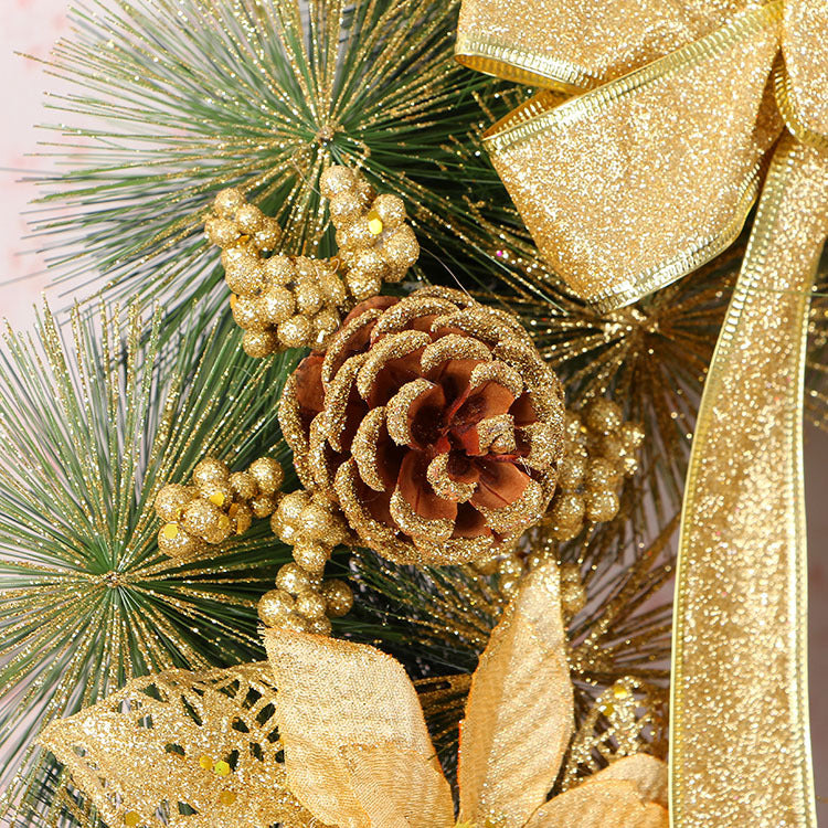 Pine needle wreath Christmas ornament surrounded by evergreen branches and ribbon