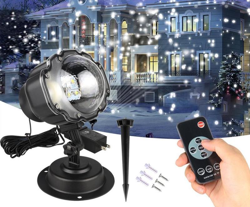 LED Snowfall Christmas Projector Light displaying bright snowflake pattern outdoors at night