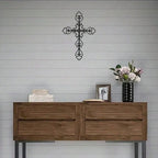 Intricate cutout cross decor piece featuring curved scrollwork details