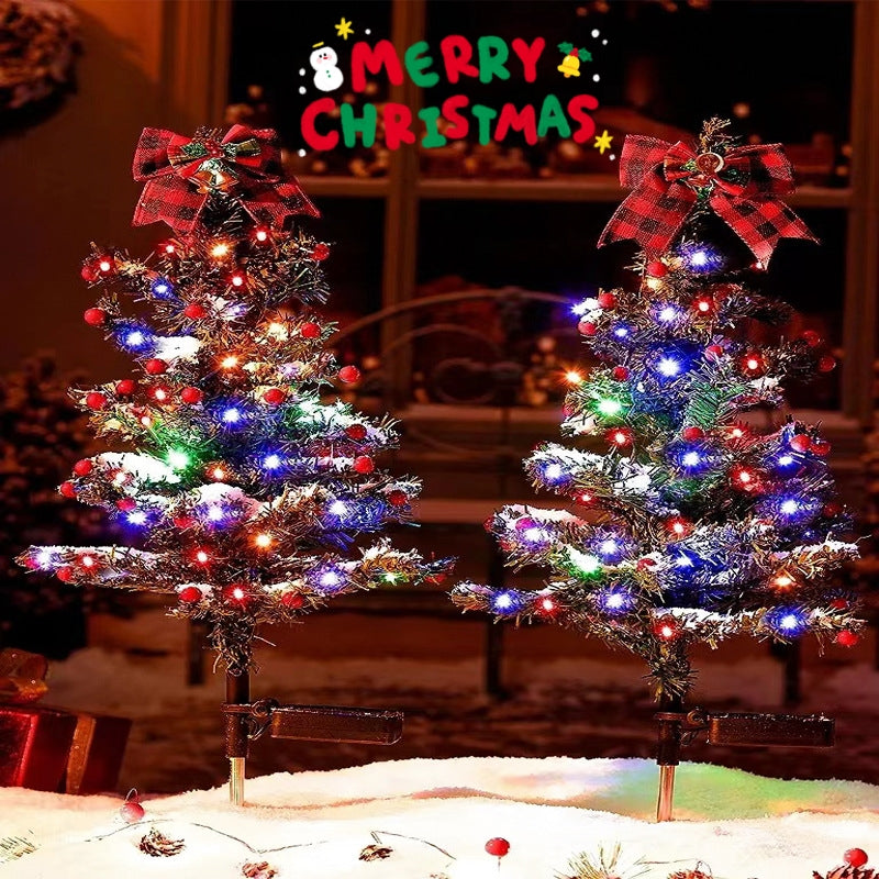 Close-up of glowing Christmas tree stake light showing intricate light patterns through green foliage