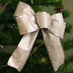 Shimmering Christmas glitter bow in red and gold colors for holiday tree