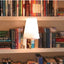 Christmas literary book lamp with warm glow illuminating a cozy room