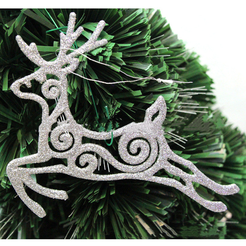 Flying deer ornament hanging on decorated Christmas tree