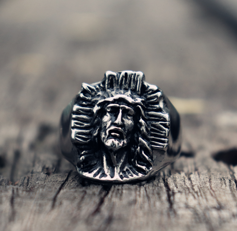 Close-up of cross symbol on stainless steel ring showing detailed craftsmanship