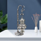 Decorative hanging censer shown at angle displaying ornate design