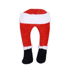 Set of elf legs Christmas garden stakes surrounded by winter greenery