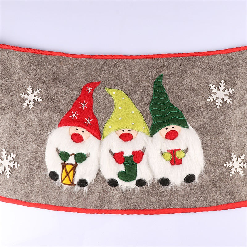 Christmas tree skirt with Nordic elders pattern styled beside wrapped presents