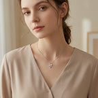 Elegant sterling silver cross necklace featuring CZ stones and pearl on a box chain